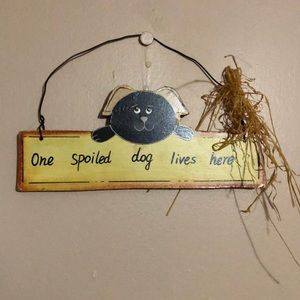 “One spoiled dog lives here” sign